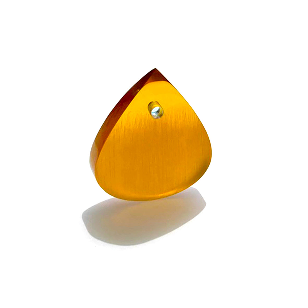 amber colored guitar pick in sunlight