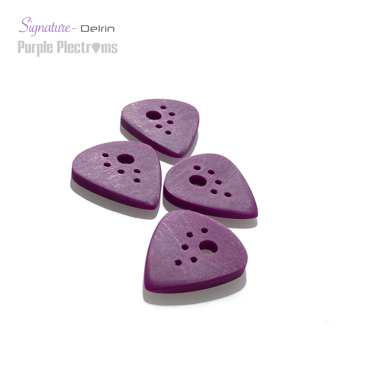 four purple guitar picks bathed in sunlight on a white background